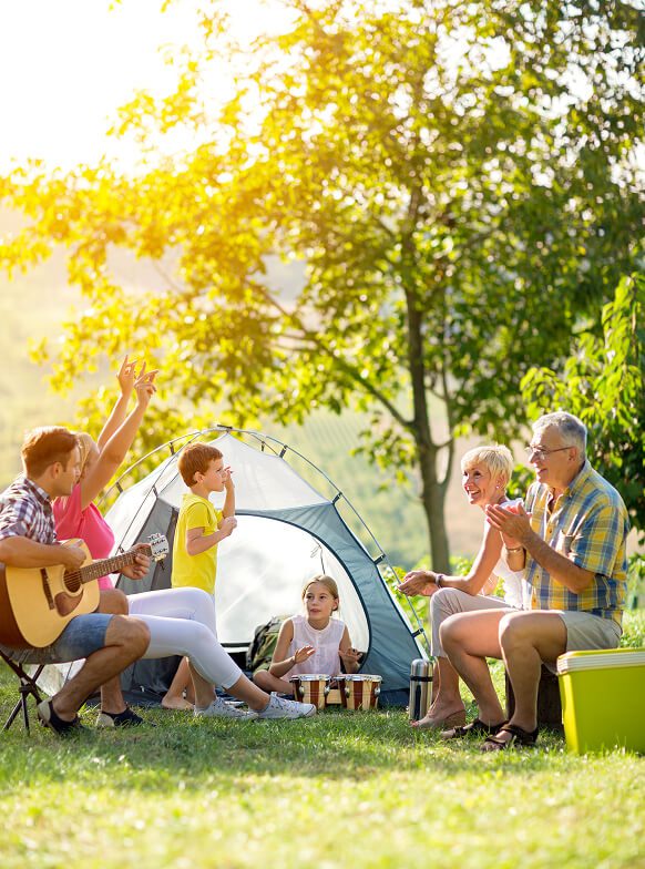 Family camping with guitar and clapping